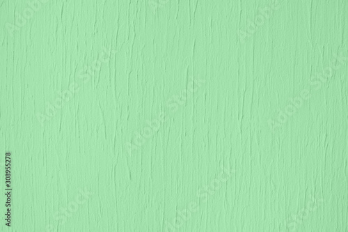 Trendy mint colored low contrast Concrete textured background with roughness and irregularities to your design or product. Year color trend concept.