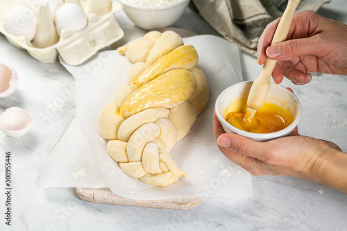 Making traditional jewish challah bread on marble background, copy space