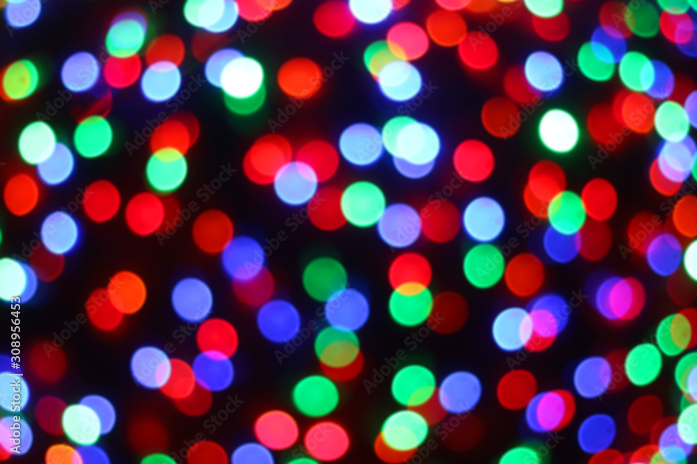 Defocused Christmas background with colorful bokeh lights.