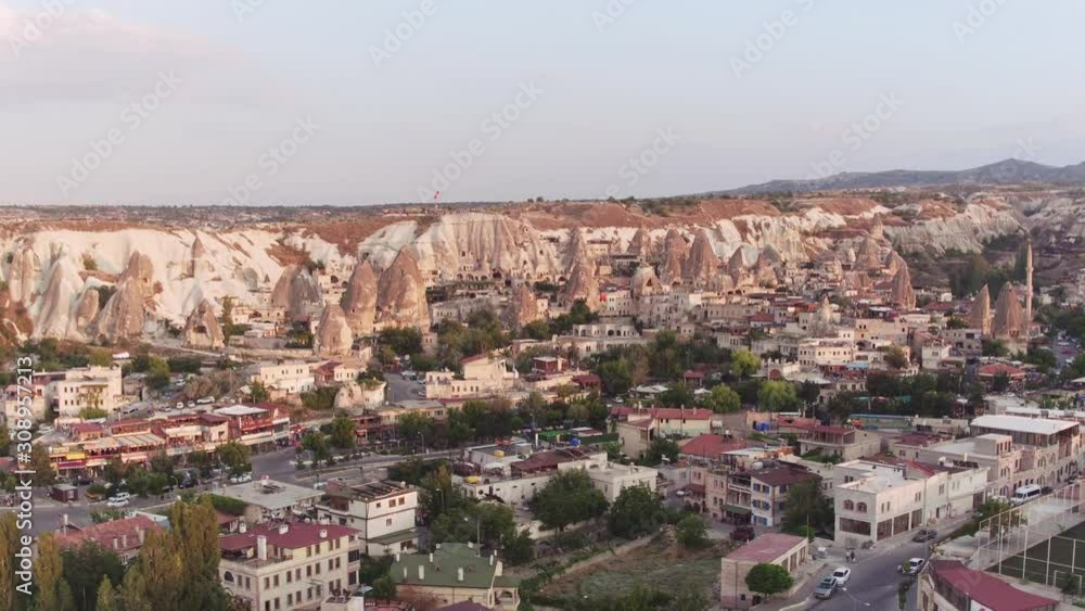 Goreme tourist village in National Park and near Love Valley at summer sunset / Cloudy evening - Aerial drone view Goreme tourist village in National Park and near Love Valley at summer sunset / Cloudy evening - Aerial drone view