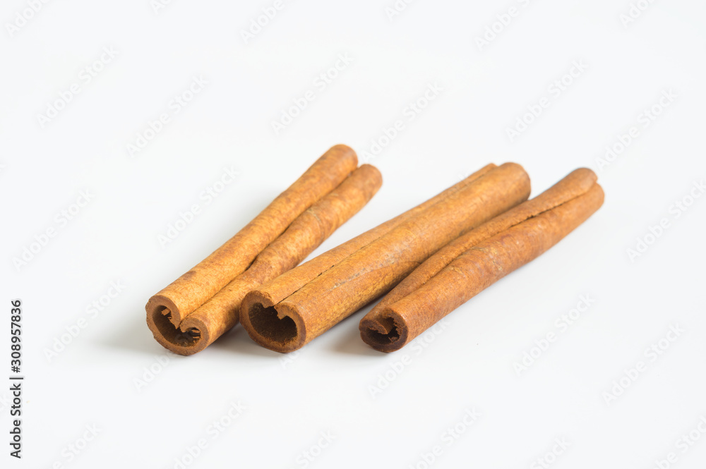 Cinnamon sticks aromatic condiment on white.