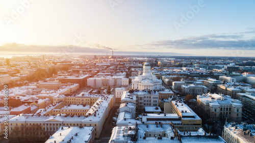 Winter susnset scenery of the Old Town in Helsinki, Finland. Snow on the roofs. Beautiful sunlight. Christmas market. View from above.  photo