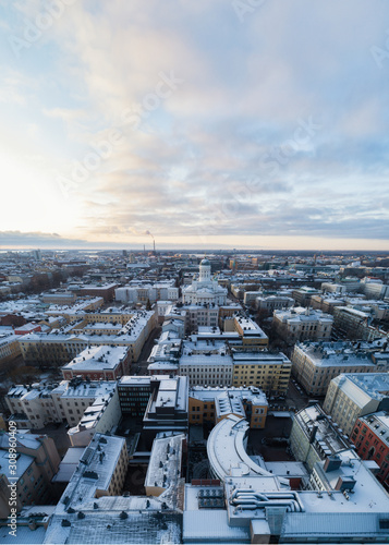 Scenic winter view of the Old town. Cathedral at sunset in Helsinki, Finland. Snow on the roofs.