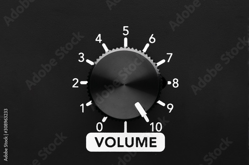 Volume control knob of a black amplifier on maxiumum loudness