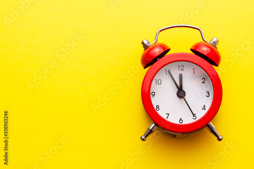 Colorful red traditional alarm clock with bells