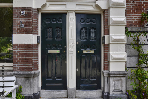 Amsterdam, Holland, August 2019. Along the river Amstel, on the outskirts of the city it is easy to meet house doors with a strong appeal to the London style.