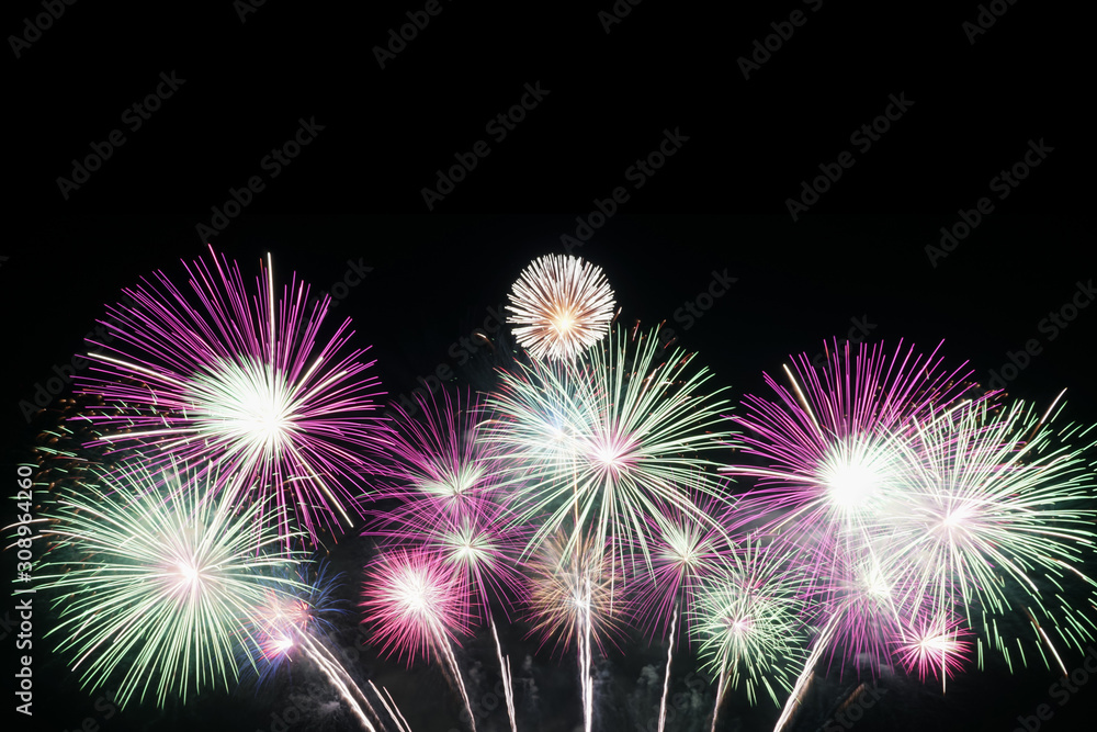 Real colorful fireworks celebration at night background with copy space for text or anything else.