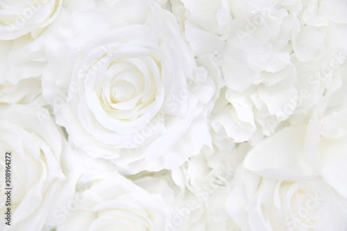 Decoration artificial white roses flower bouquet as a floral background with soft focus and copy space.