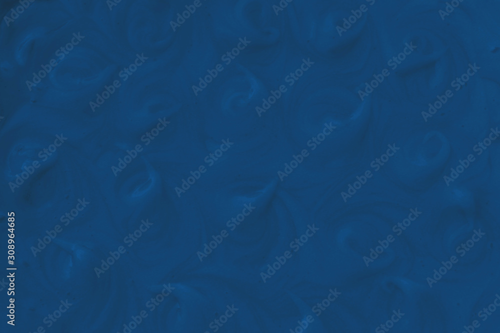 Obraz premium Cosmetic texture of purifying exfoliating scrub for face and body. Herbal skin cosmetics, cream or gel, close up. Fashionable background in classic blue pantone color of the year 2020