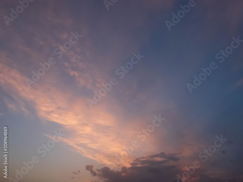 Bright multicolored clouds enlightened with rays of setting sun. Bright evening sky with pink, blue and purple cumulus, stratus and cirrus clouds © Philipp Berezhnoy