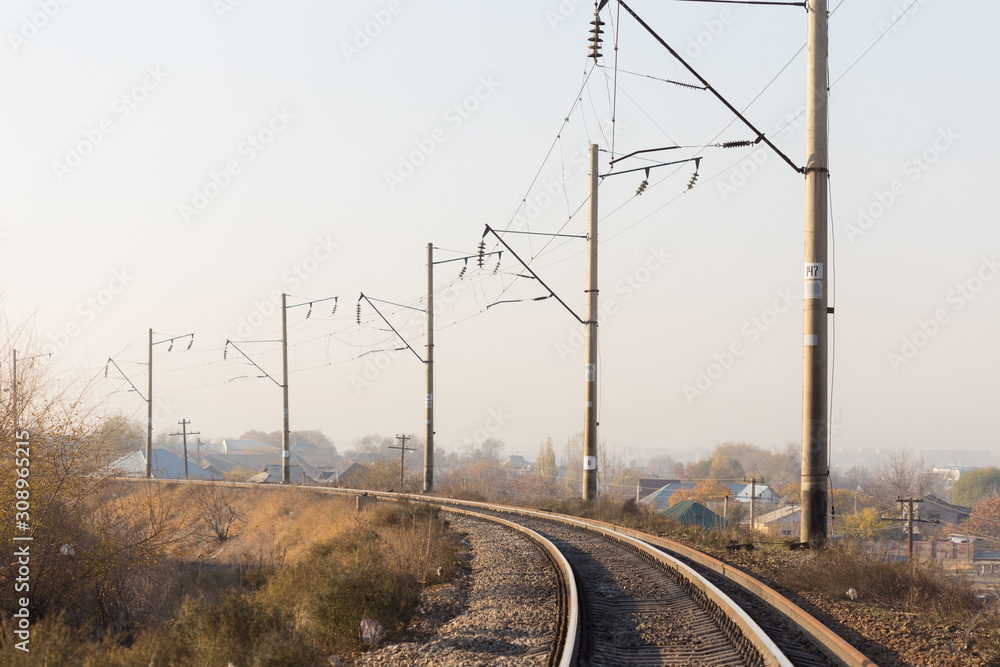 railway rails pillars wire horizon