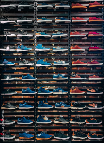 .A various types of shoes at Sport Direct shelf display rack.