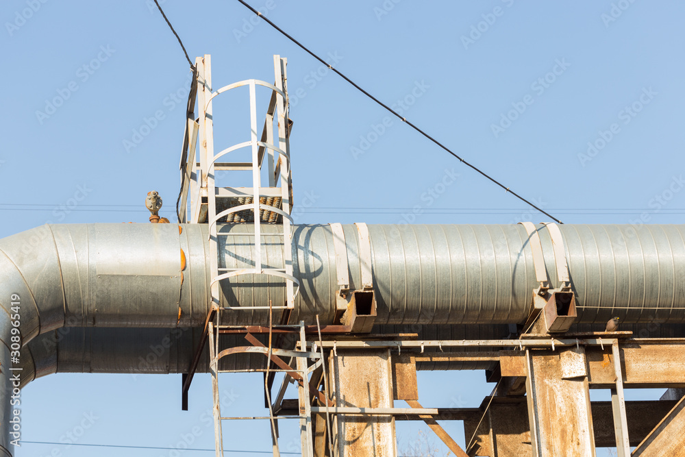 Part of the external heating system in the form of metal pipes and faucets close-up. Part of the external heating system in the form of metal pipes and faucets close-up.