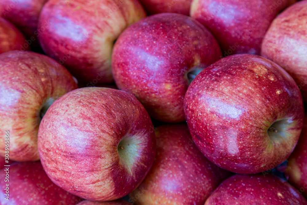 A display of red apples for sale on a market stall A display of red apples for sale on a market stall