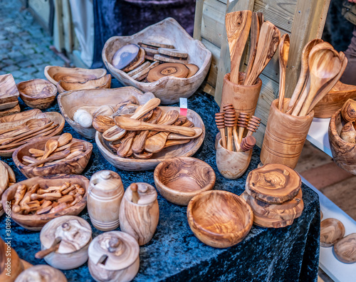 Selective focus of wooden bowls, utensils and kitchen products on display and for sale at the 2019 Christmas market in Maastricht, Netherlands