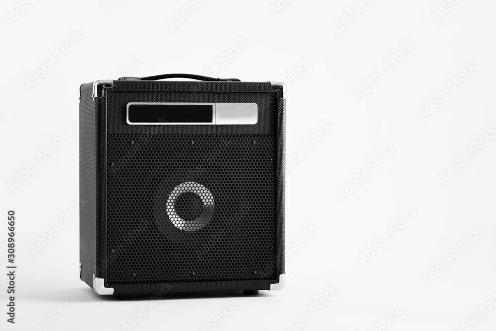 Black electric guitar bass amplifier on white background
