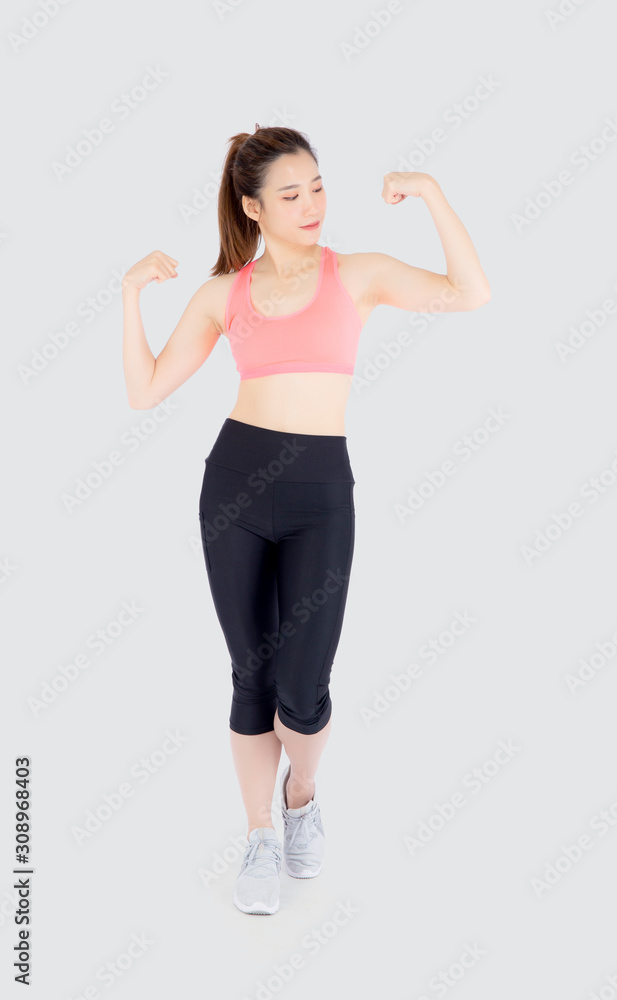 Beautiful portrait young asian woman wear sport clothes strong and muscle with health, girl show biceps with exercise and workout for wellness isolated on white background, strength and fit concept. Beautiful portrait young asian woman wear sport clothes strong and muscle with health, girl show biceps with exercise and workout for wellness isolated on white background, strength and fit concept.