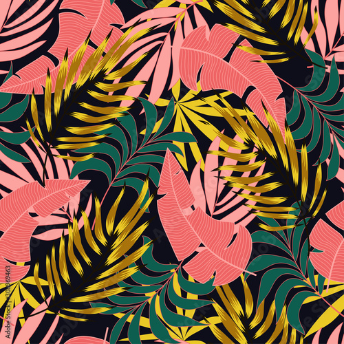 Fashionable seamless tropical pattern with bright pink and green plants and leaves on dark background. Summer colorful hawaiian seamless pattern with tropical plants. Printing and textiles. 