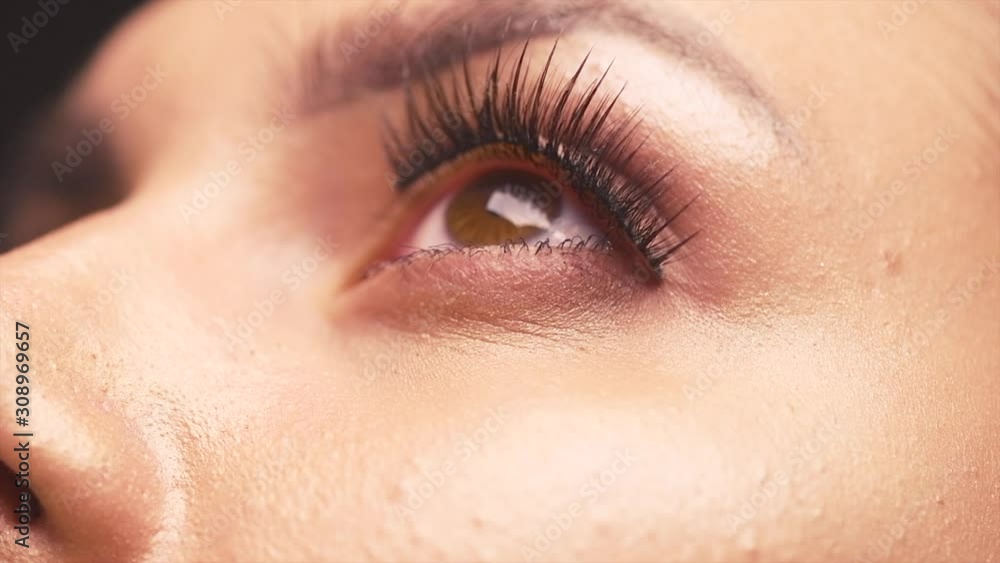 Beauty Woman Eye Makeup closeup. Beautiful Holiday Make-up for Brown Eyes. False eyelashes, Night Party. Macro. Cosmetics, eyeshadow, fashion, glamour. Beauty Woman Eye Makeup closeup. Beautiful Holiday Make-up for Brown Eyes. False eyelashes, Night Party. Macro. Cosmetics, eyeshadow, fashion, glamour.