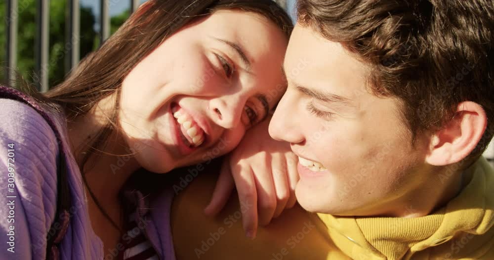 Teenager couple hanging out in their school grounds Teenager couple hanging out in their school grounds