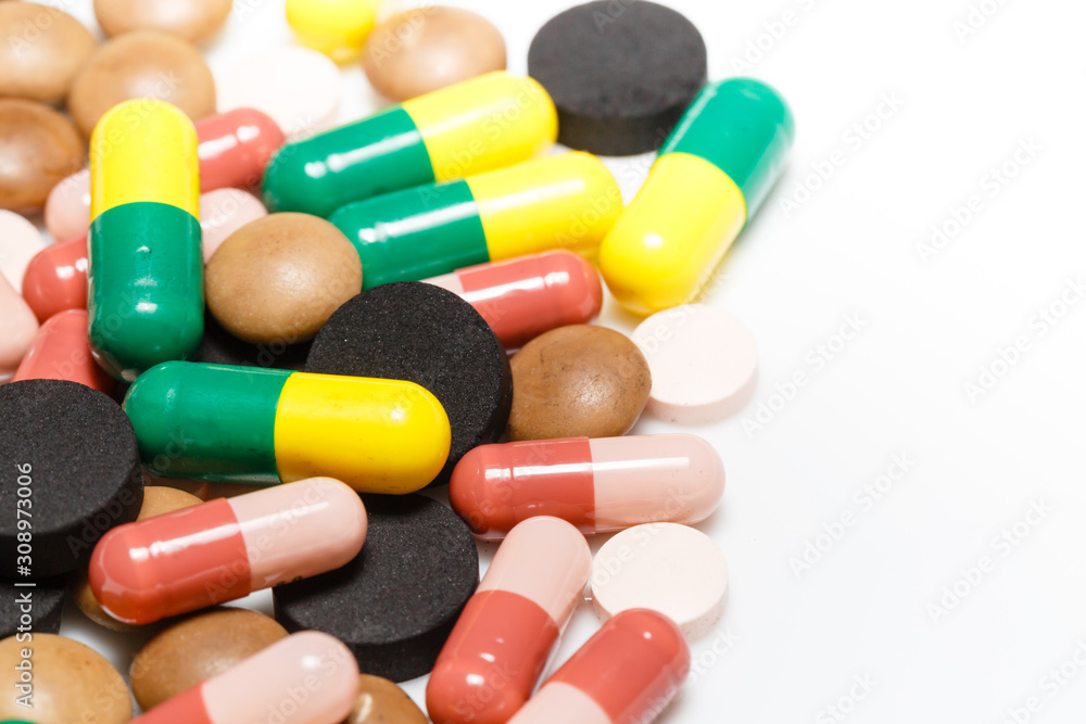 Various pills and capsules on white background closeup view