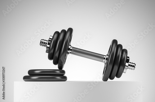 Heavy black professional dumbbell for fitness and bodybuilding with two weight plates on the white podium. Front view with white background.