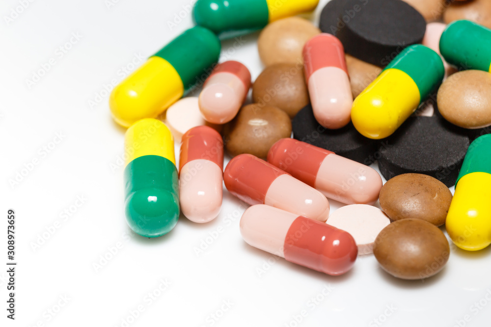 Various pills and capsules on white background closeup view Various pills and capsules on white background closeup view