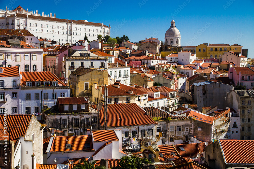 Fototapeta premium Lisbon, Portugal: Aerial View of the Old Alfama Quarter on the Hill with Blue Sky