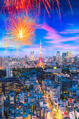 Cityscape of Tokyo, city with firework display for celebration, aerial skyscraper view of office building and downtown and street of minato in tokyo with sunset / sun rise background. Japan, Asia
