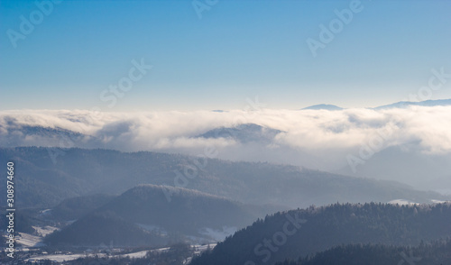 Fog in Beskid Sadecki Mountains in winter. View from Jaworzyna Krynicka, Poland.