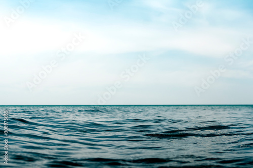 Natural dark blue seawater surface with blue sky
