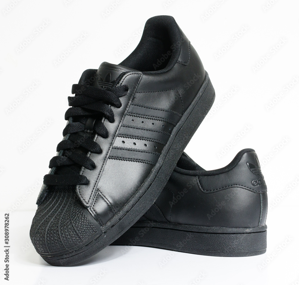 london, england, 05/05/2018 adidas superstar shell toe originals hip hop  style vintage sneaker trainers. all black adidas superstar trainers,  stylish retro new york street fashion. Stock 写真 | Adobe Stock