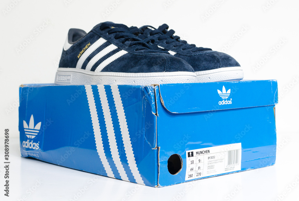 london, england, 05/05/2018 Adidas Munchen gazelle vintage sneaker trainers. suede adidas trainers, stylish retro football street fashion. famous three stripes Stock Photo | Adobe Stock