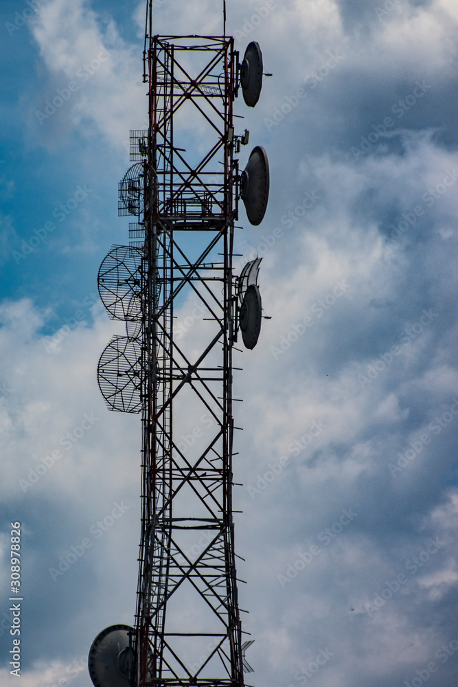 telecommunications antenna in blue sky with clouds telecommunications antenna in blue sky with clouds