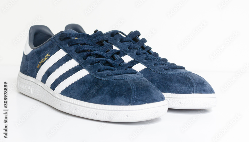 london, england, 05/05/2018 Adidas Munchen gazelle vintage sneaker trainers.  Blue suede adidas trainers, stylish retro football street fashion. famous  three stripes Stock Photo | Adobe Stock