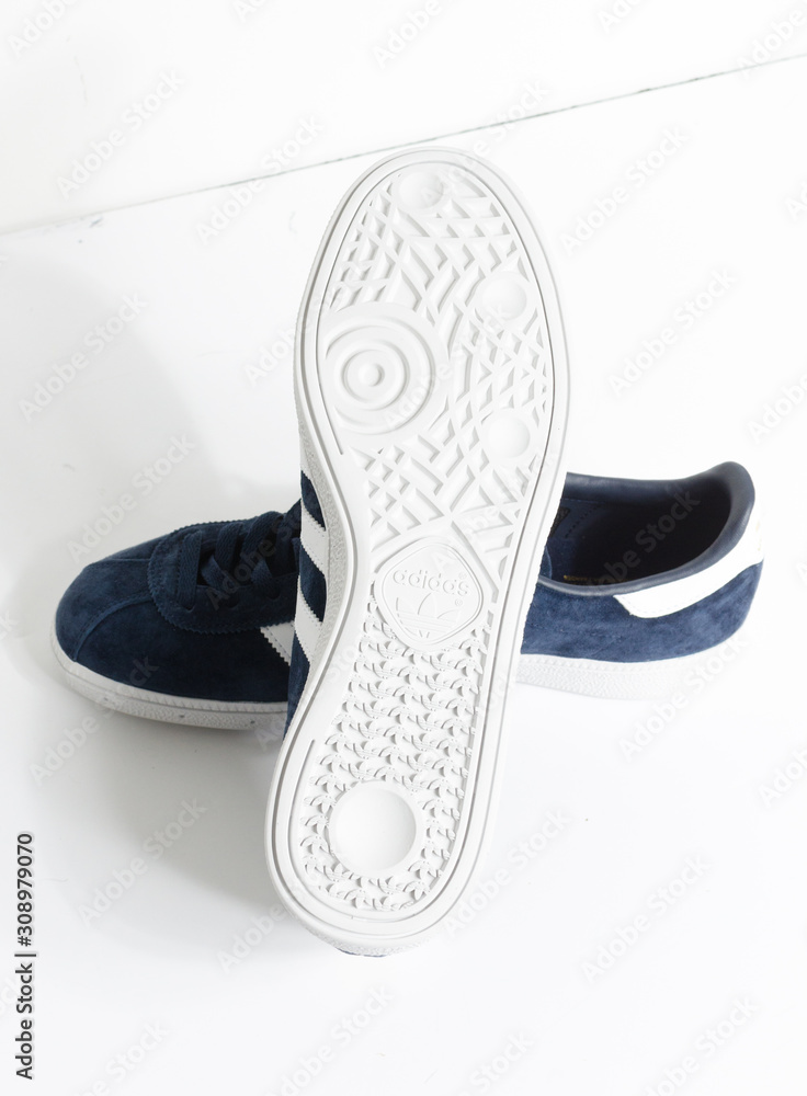 london, england, 05/05/2018 Adidas Munchen gazelle vintage sneaker  trainers. Blue suede adidas trainers, stylish retro football street  fashion. famous three stripes Stock Photo | Adobe Stock