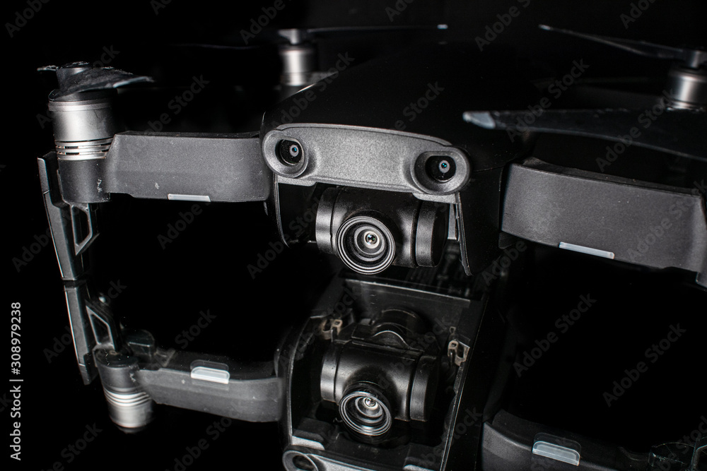 Camera drone with reflection on shiny black background