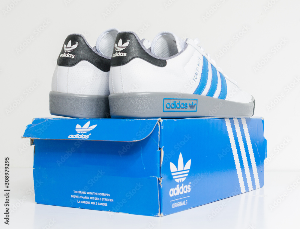 london, england, 05/05/2018 Adidas Forest Hills White grey and blue vintage  sneaker trainers. Blue stripe adidas trainers, stylish retro football  street fashion. famous three stripes Stock 写真 | Adobe Stock
