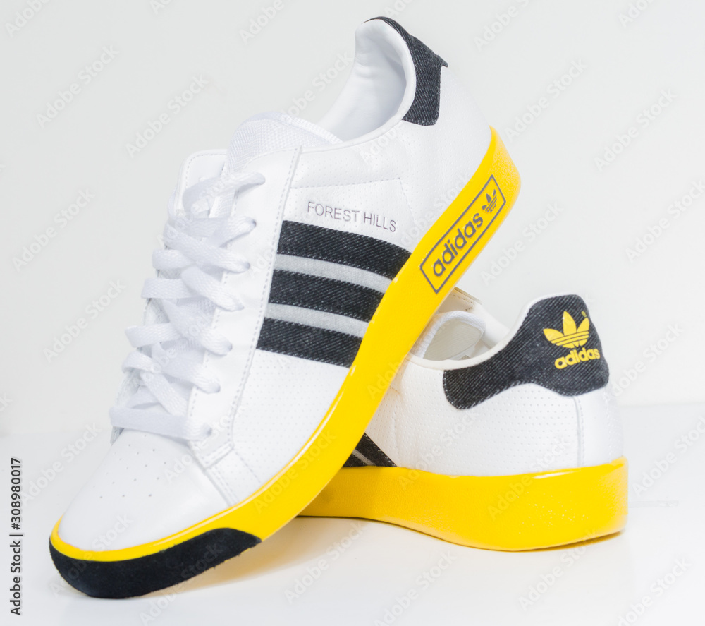 london, england, 05/05/2018 Adidas Forest Hills Vin White DK Grey/Sunshine vintage sneaker trainers. Blue suede adidas trainers, stylish retro football street fashion. three stripes foto de | Adobe Stock