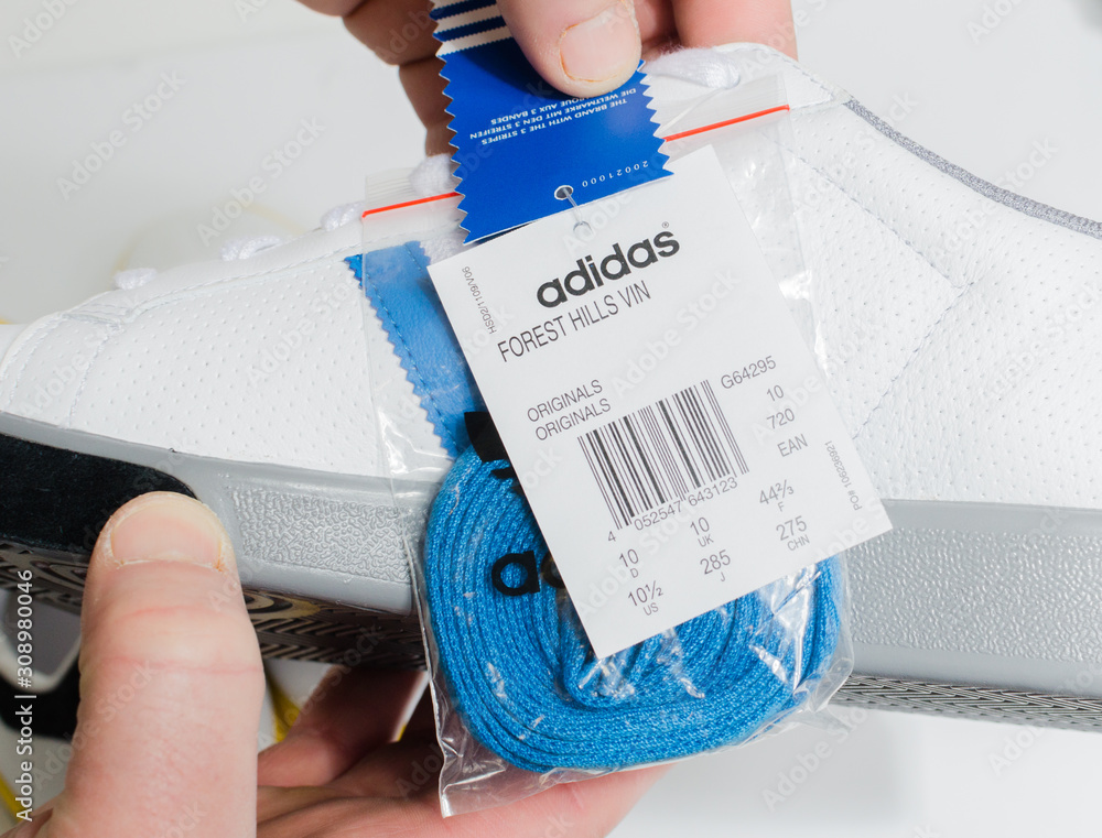 england, 05/05/2018 Adidas Forest Hills White grey blue vintage sneaker trainers. Blue stripe adidas trainers, stylish retro football street fashion. famous three stripes Stock Photo | Adobe