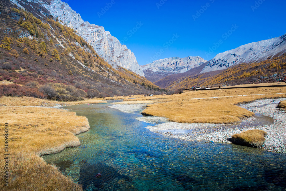 Pure water from the melting of Snow Mountains with blue sky in the background at Yading Nature Reserve, Sichuan, China Pure water from the melting of Snow Mountains with blue sky in the background at Yading Nature Reserve, Sichuan, China