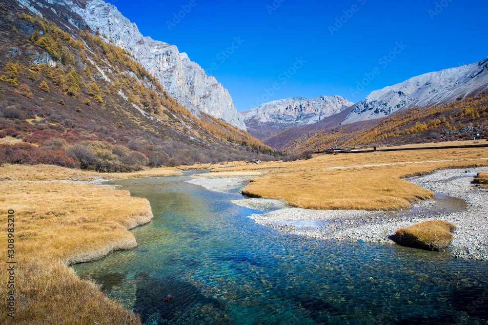 Pure water from the melting of Snow Mountains with blue sky in the background at Yading Nature Reserve, Sichuan, China