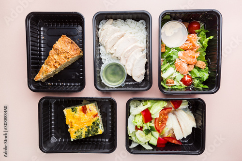 Healthy food delivery. Take away food for diet. Fitness nutrition, balanced proteins, fats and carbohydrates in plastic boxes. Top view, flat lay.