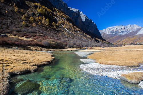 Pure water from the melting of Snow Mountains with blue sky in the background at Yading Nature Reserve, Sichuan, China