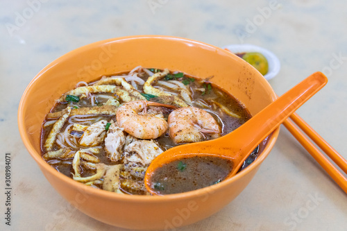 Simple no frills Sarawak laksa with prawn and chicken meat photo
