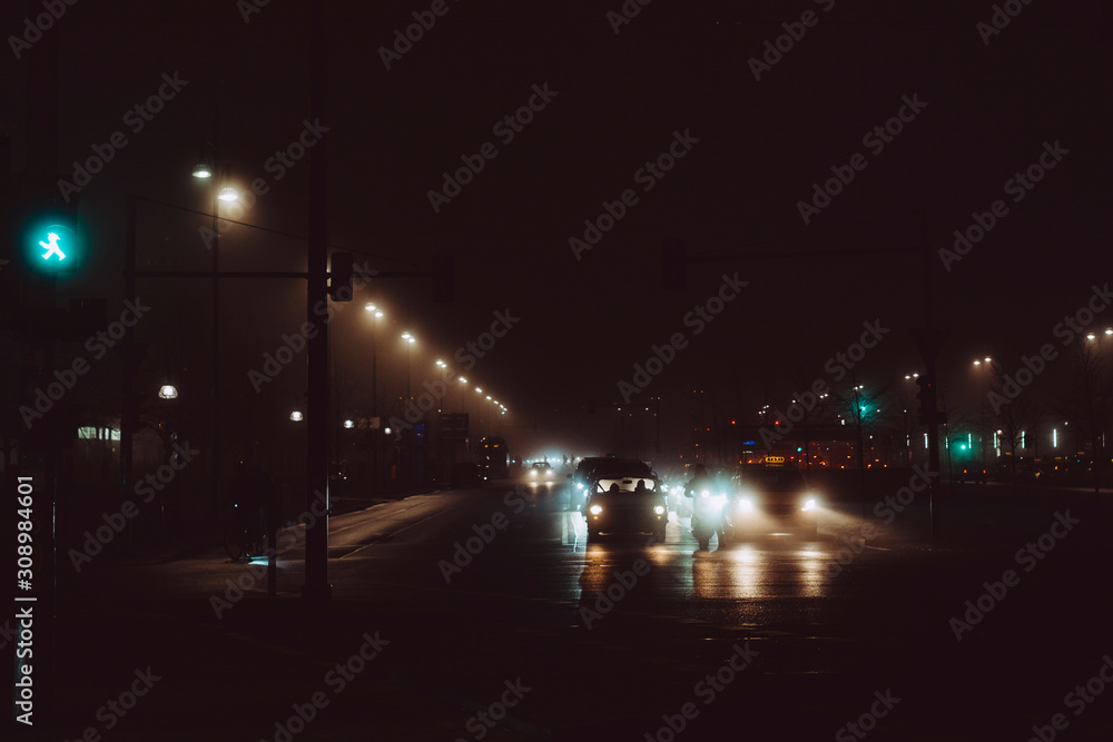 Car light in foggy Berlin night
