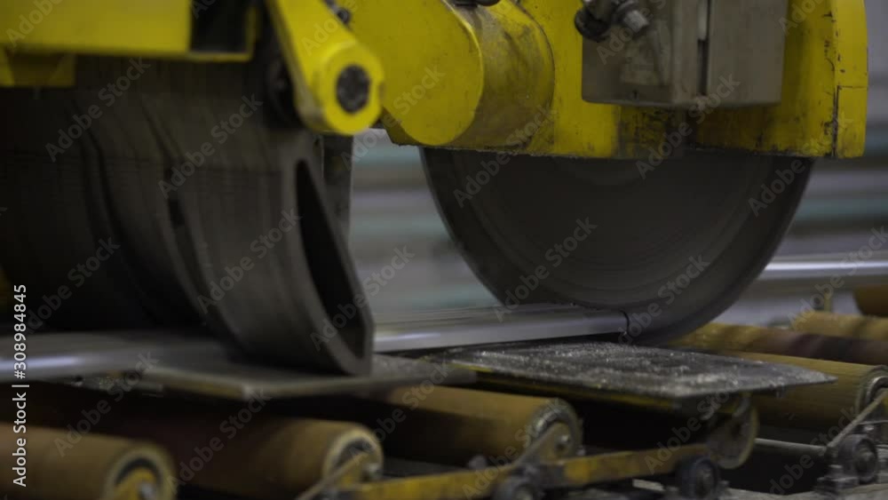 Close up of Cutting aluminium profile with robotic circular saw in manufacture. Aluminium Windows and Doors Manufacturing. Close up of Cutting aluminium profile with robotic circular saw in manufacture. Aluminium Windows and Doors Manufacturing.