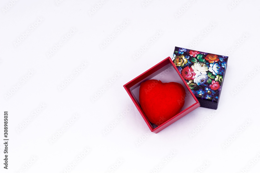 A gift from the heart of a colored cardboard box with a lid. A gift from the heart of a colored cardboard box with a lid.