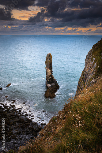 Sunrise at stack rocks on dramatic Pembrokeshire coast, South Wales, Uk.Scenic coastline landscape with coastal feature, rocky cliffs and turquoise sea water. 