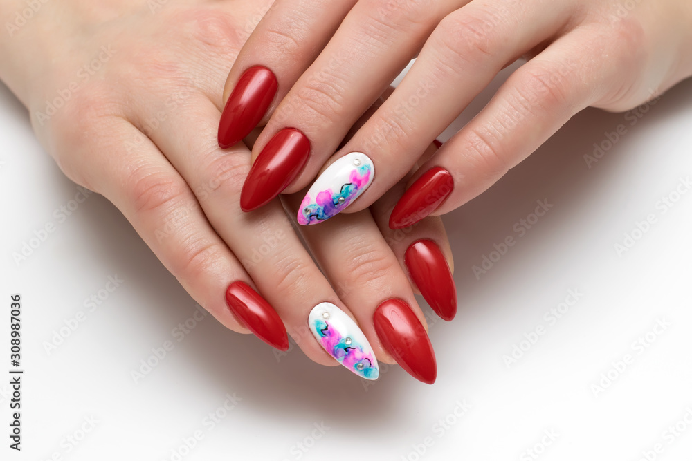Red manicure on long sharp nails. White Nail Abstraction. Crystals. Ink painting. Red manicure on long sharp nails. White Nail Abstraction. Crystals. Ink painting.